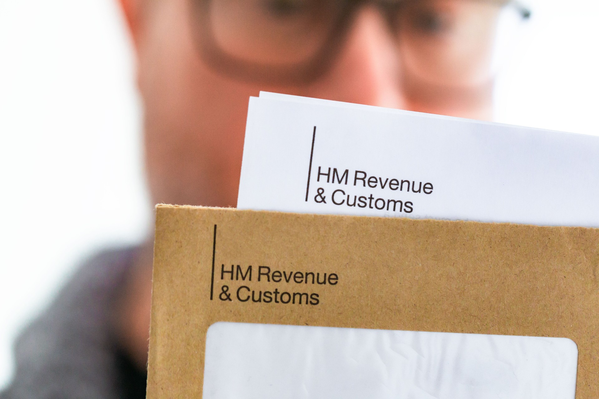 Mid adult man opening HMRC tax letter